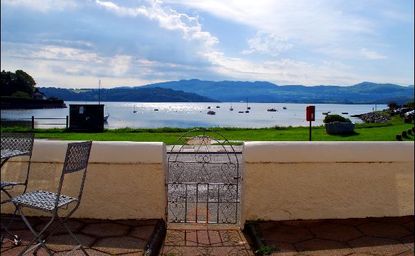 Borth -Y -Gest harbour, North Wales, viewed from the fron
					m the front garden. A front gate with the Snowdonia mountains and Glaslyn estuary in the background