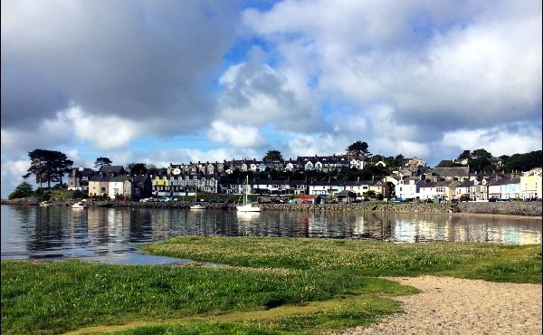 Borth -Y -Gest harbour, North Wales, Sunny day.The tide is in, the boats are floating and the village is reflected in the water